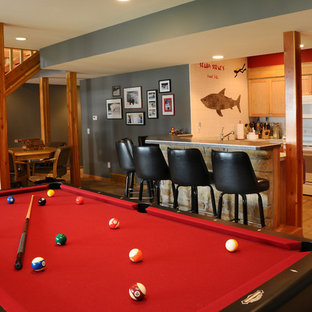 This is an example of a traditional look-out basement in Other with grey walls, no fireplace and travertine flooring.