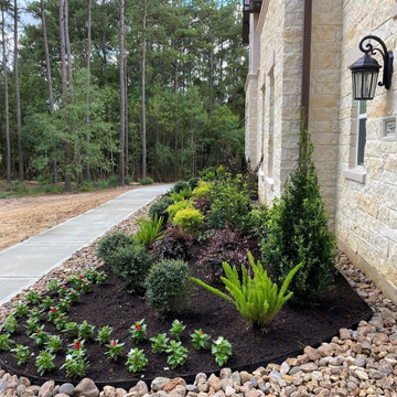 This border of rock around the foundation helps to facilitate plant maintenance