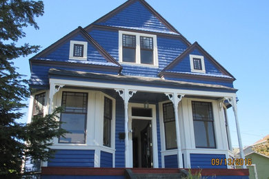 Inspiration for a mid-sized timeless blue two-story wood exterior home remodel in Seattle with a hip roof