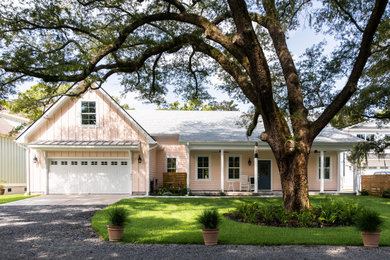 Example of a transitional pink one-story exterior home design in Charleston with a shingle roof and a gray roof