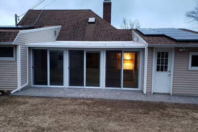 Patio - large traditional backyard patio idea in New York