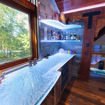 Glass private bar and glass stair treads inside a man cave in Michigan