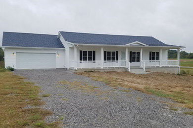 Elegant white one-story vinyl exterior home photo in Other with a shingle roof