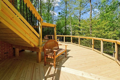 Inspiration for a huge timeless backyard deck remodel in DC Metro with no cover