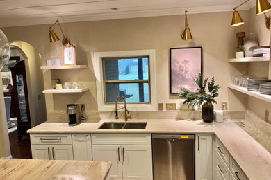 Eat-in kitchen - mid-sized modern u-shaped dark wood floor and brown floor eat-in kitchen idea in Nashville with a double-bowl sink, raised-panel cabinets, white cabinets, quartzite countertops, beige backsplash, stone slab backsplash, stainless steel appliances, an island and beige countertops