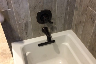 Mid-sized elegant master bathroom photo in Houston with raised-panel cabinets, dark wood cabinets, a two-piece toilet, gray walls, an undermount sink and solid surface countertops