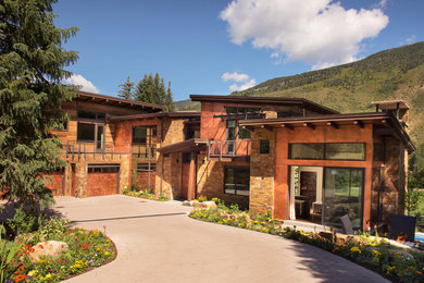 Expansive contemporary three-storey brown exterior in Denver with mixed siding.