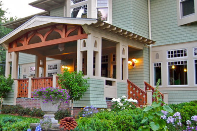 Large arts and crafts front yard verandah in New York with brick pavers and a roof extension.