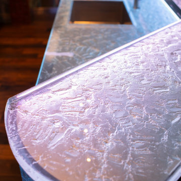 Glass private bar and glass stair treads inside a man cave in Michigan