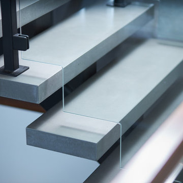 Steel and Concrete Mono Stringer with Clamped Glass Railing System