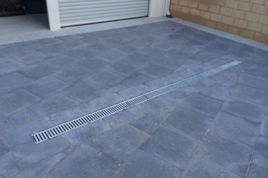 Modern partial sun driveway in Perth with natural stone pavers.