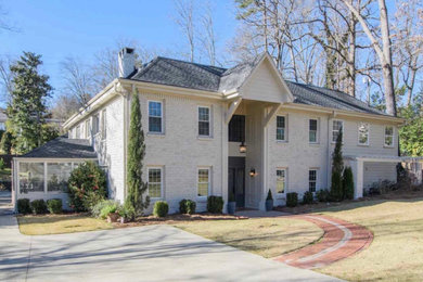 Large cottage white two-story painted brick house exterior photo in Birmingham with a hip roof, a shingle roof and a gray roof