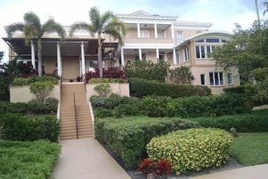 Example of a huge tuscan multicolored three-story concrete house exterior design in Other