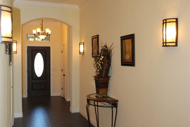 Design ideas for a mid-sized traditional entry hall in Dallas with beige walls, dark hardwood floors, a single front door, a dark wood front door and brown floor.