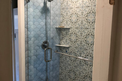 Bathroom - small eclectic master multicolored tile and ceramic tile ceramic tile, multicolored floor and single-sink bathroom idea in Denver with raised-panel cabinets, white cabinets, a two-piece toilet, blue walls, an integrated sink, quartz countertops, a hinged shower door, white countertops and a freestanding vanity