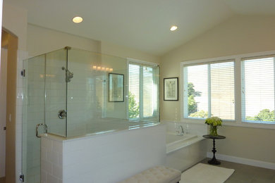 Inspiration for a mid-sized contemporary master bathroom in San Francisco with black cabinets, white tile, porcelain tile, porcelain floors, marble benchtops, a corner tub, beige walls and an undermount sink.