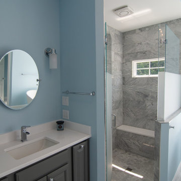 Traditional master bath utilizing frosted and clear glass to allow for needed pr