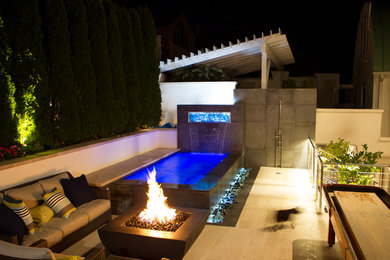 Inspiration for a mid-sized beach style backyard patio in New York with a fire feature, concrete pavers and no cover.