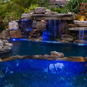 Custom Rock Waterfall Pool with Stone Grotto, Stream and Tiki Hut