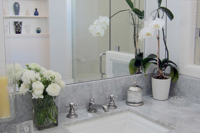 Inspiration for a mid-sized timeless master white tile and subway tile mosaic tile floor doorless shower remodel in Los Angeles with an undermount sink, shaker cabinets, white cabinets, marble countertops and gray walls