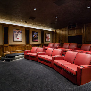 Example of a mountain style enclosed carpeted and gray floor home theater design in Wichita with brown walls and a projector screen