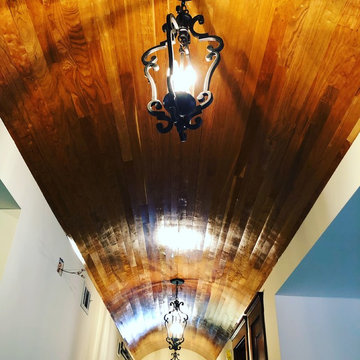 Cherry wood barrel ceiling with traditional pendant light fixture