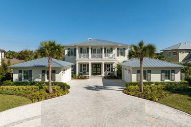 Inspiration for a coastal white two-story house exterior remodel in Jacksonville with a metal roof