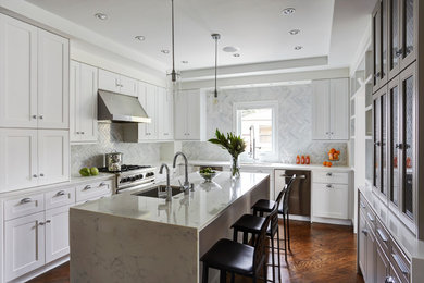 Eat-in kitchen - mid-sized transitional u-shaped medium tone wood floor eat-in kitchen idea in Chicago with an undermount sink, shaker cabinets, white cabinets, solid surface countertops, blue backsplash, stone tile backsplash, stainless steel appliances and an island