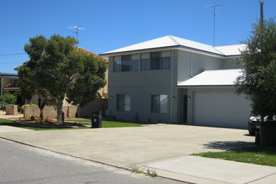 Traditional two-storey grey house exterior in Perth with a hip roof and a metal roof.