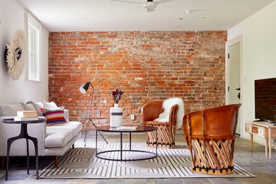 Inspiration for a contemporary slate floor and gray floor living room remodel in New Orleans with white walls