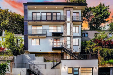 シアトルにあるラグジュアリーなコンテンポラリースタイルのおしゃれな家の外観 (コンクリートサイディング、混合材屋根、縦張り) の写真
