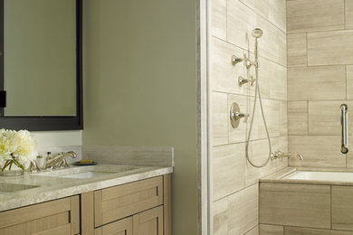 Tub/shower combo - transitional master beige tile and marble tile mosaic tile floor tub/shower combo idea in New York with an undermount tub, beige walls and an undermount sink
