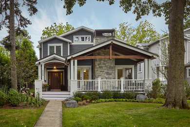 Design ideas for a mid-sized arts and crafts two-storey blue exterior in Chicago with wood siding and a gable roof.