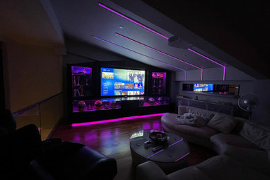 Example of a mid-sized home theater design in Other with a projector screen