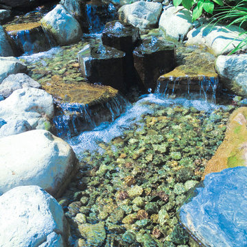 pondless waterfall with basalt columns and river rock stream