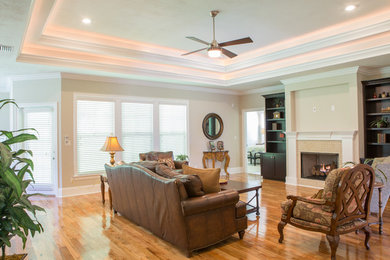 Large arts and crafts open concept medium tone wood floor living room photo in Atlanta with beige walls, a standard fireplace and a stone fireplace