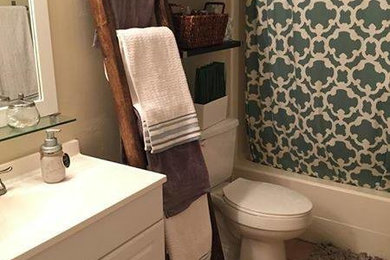 Inspiration for a mid-sized timeless 3/4 ceramic tile and beige floor bathroom remodel in Tampa with raised-panel cabinets, white cabinets, a two-piece toilet, beige walls, an integrated sink, solid surface countertops and white countertops