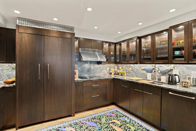 Large modern u-shaped kitchen/diner in DC Metro with a submerged sink, flat-panel cabinets, dark wood cabinets, multi-coloured splashback, stainless steel appliances and an island.