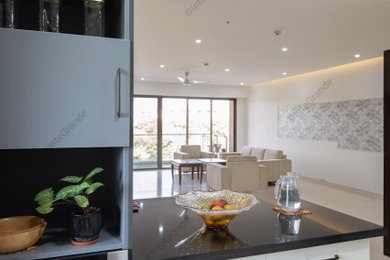 Inspiration for a large modern l-shaped marble floor and beige floor eat-in kitchen remodel in Bengaluru with granite countertops, a peninsula and black countertops