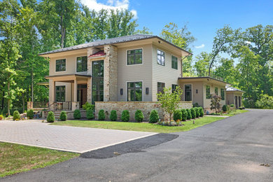 Inspiration for a huge beige two-story house exterior remodel in Philadelphia