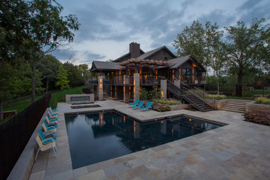 Backyard stone and l-shaped pool photo in Kansas City