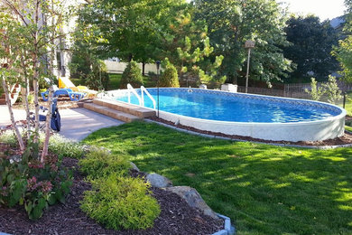 Pool - mid-sized traditional backyard custom-shaped aboveground pool idea in Other