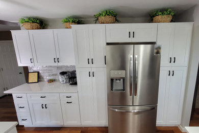 Example of a mid-sized trendy u-shaped kitchen pantry design in Philadelphia with shaker cabinets, white cabinets, quartz countertops and white countertops
