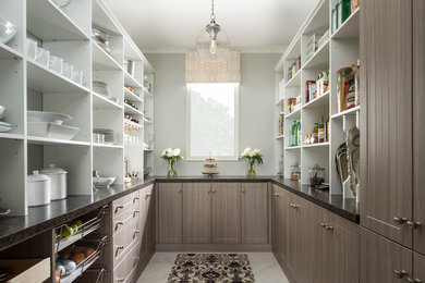 Example of a large minimalist u-shaped porcelain tile kitchen pantry design in Other with shaker cabinets, brown cabinets, granite countertops and blue countertops