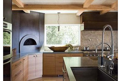 Inspiration for a contemporary kitchen in San Francisco with an undermount sink, flat-panel cabinets, light wood cabinets, granite benchtops, multi-coloured splashback, stone slab splashback, stainless steel appliances, limestone floors and multiple islands.