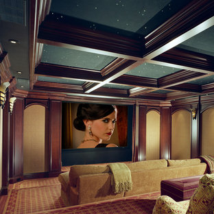 Photo of a large mediterranean enclosed home cinema in Other with yellow walls, carpet, a projector screen and multi-coloured floors.