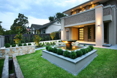 This is an example of a mid-sized contemporary garden in Melbourne with a water feature.