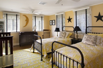 Inspiration for a large traditional kids' bedroom for kids 4-10 years old and girls in Los Angeles with yellow walls and medium hardwood floors.