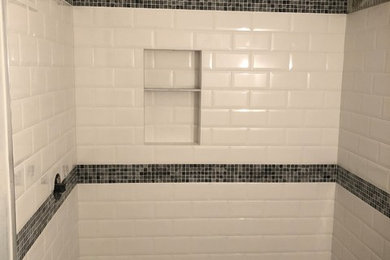 Example of a large transitional master white tile and subway tile limestone floor, gray floor and single-sink bathroom design in New York with white walls, shaker cabinets, white cabinets, gray countertops, a freestanding vanity, an undermount sink and a one-piece toilet