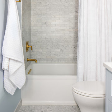 Around the Corner Condo marble and brass shower and tub